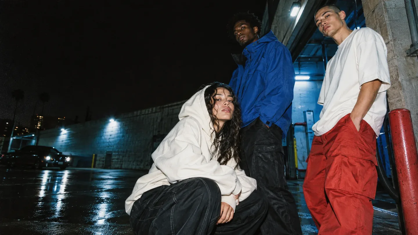 AFTERIMAGE campaign photography: three models at night in a lit parking structure.