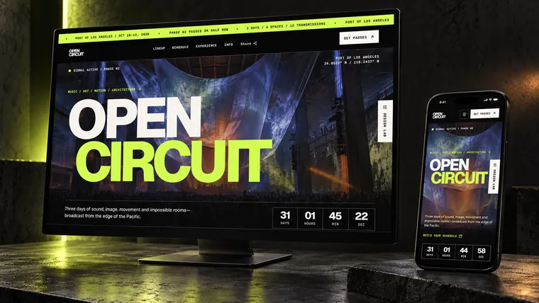 The OPEN CIRCUIT event site on a monitor and a phone, counting down to a three-day programme.
